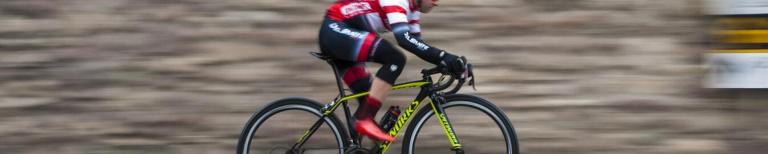 Wielrennen in de winter Persoon op racefiets door de stad
